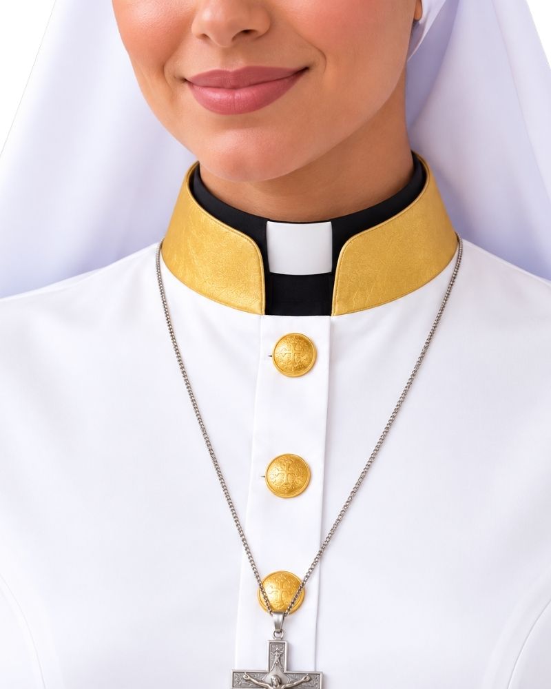 A close-up of a woman wearing a Aria White Clergy Robe With Gold with a gold and black collar, wearing a silver crucifix necklace.