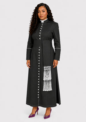 Woman wearing a black robe with white buttons and fringes on a white background