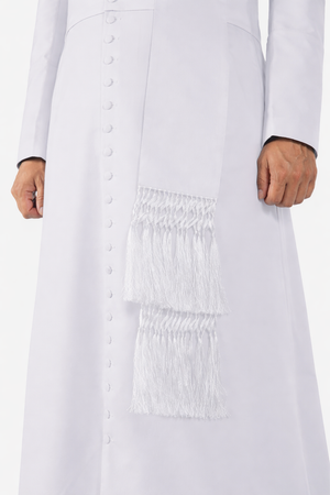 White dress with smocked waist and fringe details on a white background