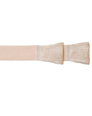 A close-up of a beige fabric strap or band with two wide, soft bristle ends, shown against a plain white background.