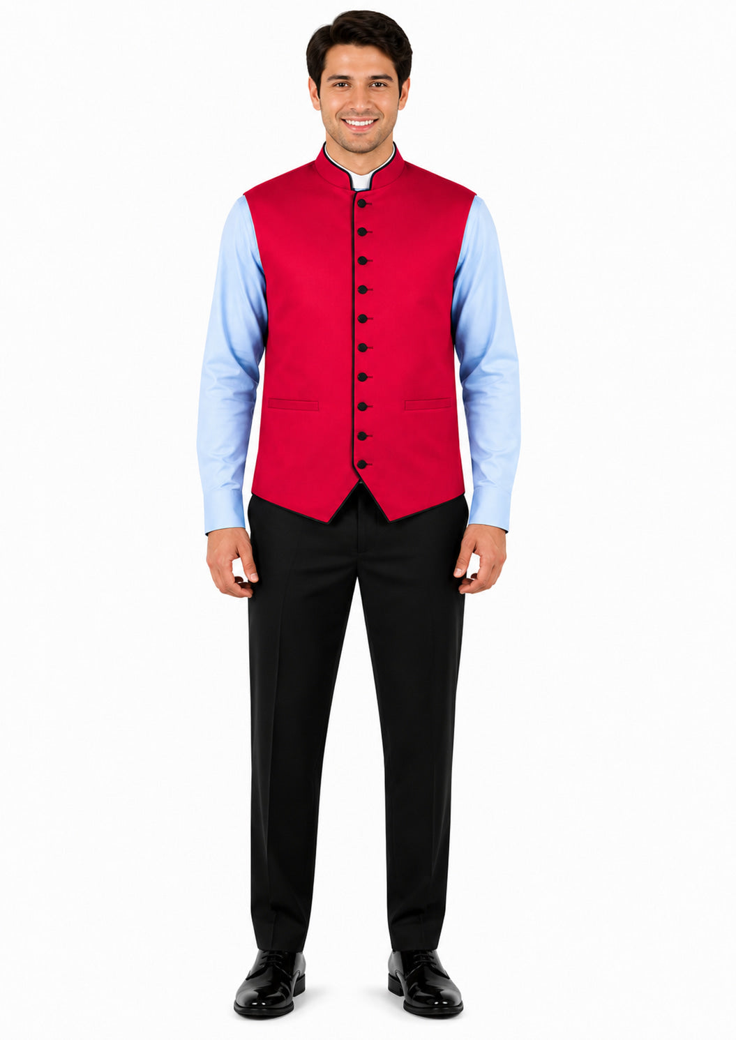 Man wearing a red vest over a light blue shirt with black pants on a white background