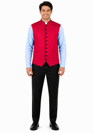 Man wearing a red vest over a light blue shirt with black pants on a white background