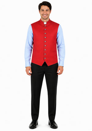 Man wearing a red vest over a light blue shirt with black pants on a white background