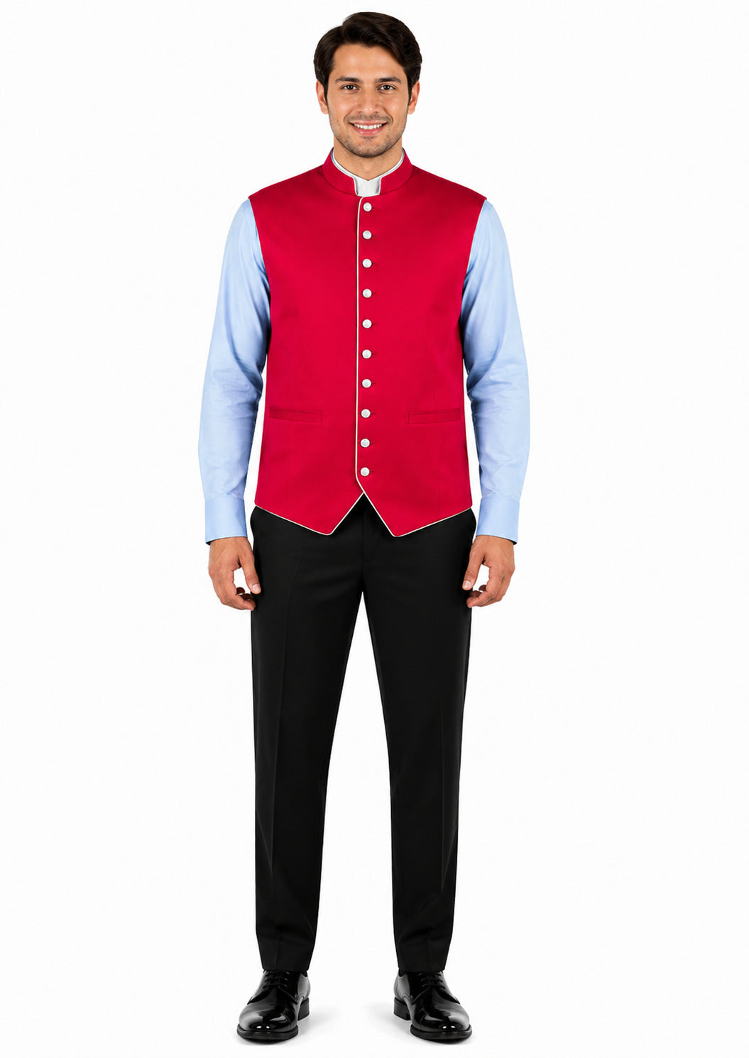 Man wearing a red vest over a light blue shirt with black pants on a white background