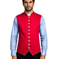 A man wearing a bright red waistcoat vest over a light blue dress shirt and black trousers, photographed against a white background.