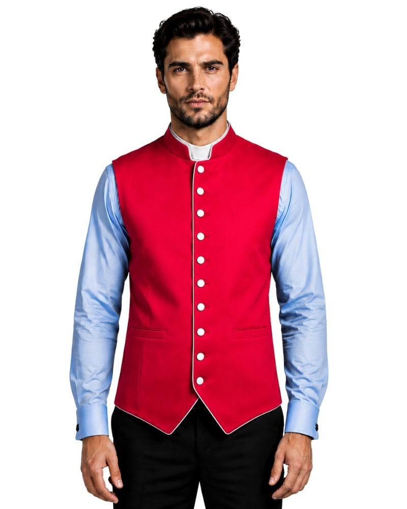 A man wearing a bright red waistcoat vest over a light blue dress shirt and black trousers, photographed against a white background.