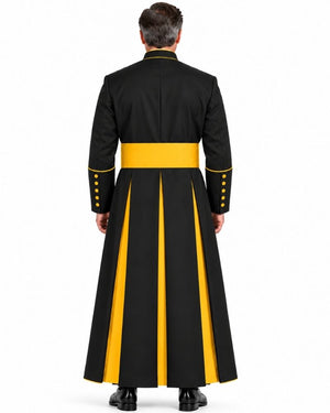 A man viewed from the back wearing a Black Roman Cassock With Yellow Trim and gold buttons on the sleeves, against a plain white background.