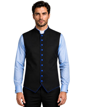 A man wearing a black waistcoat with royal blue trim and matching blue buttons, layered over a light blue dress shirt and black trousers, against a white background.