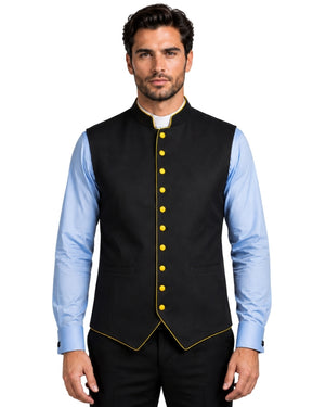 A man wearing a black waistcoat with purple trim and purple buttons, layered over a light blue dress shirt and black trousers, against a white background.
