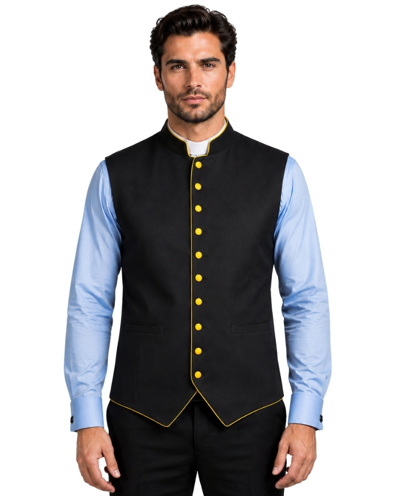A man wearing a black waistcoat with purple trim and purple buttons, layered over a light blue dress shirt and black trousers, against a white background.