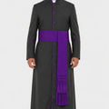 Man wearing a black robe with a purple sash on a white background