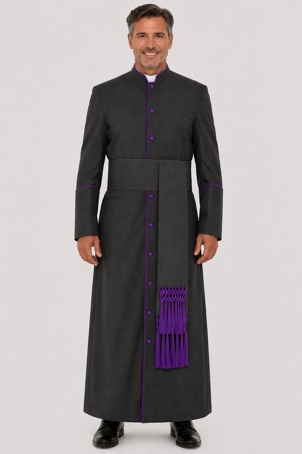Man wearing a black robe with purple accents on a gray background