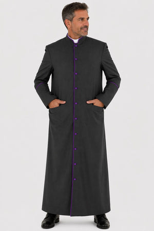 Man wearing a long black coat with purple buttons on a white background