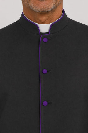 Black shirt with purple buttons on a plain background