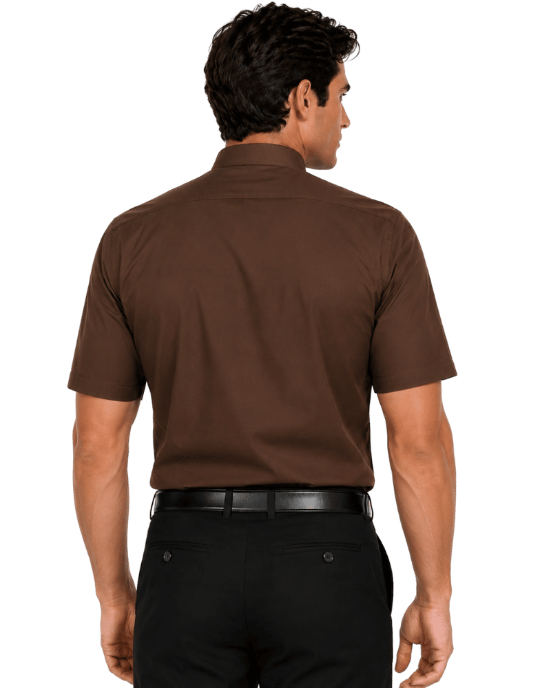 A man shown from the back wearing a short-sleeve brown clerical shirt and black pants against a plain white background.