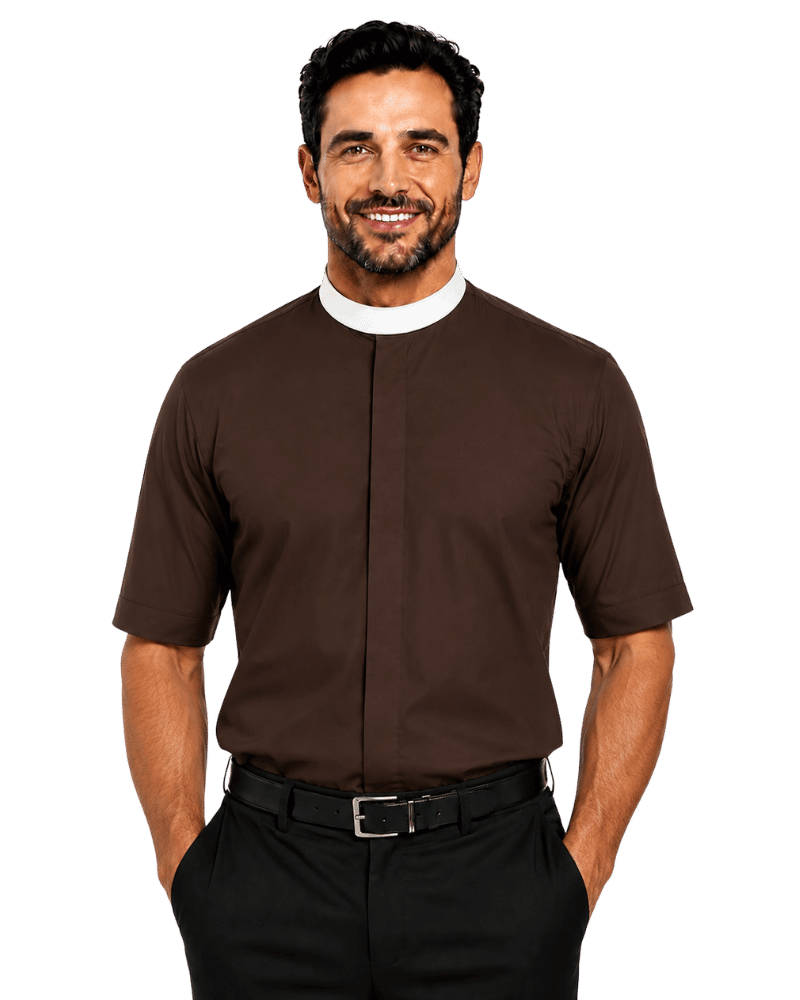 A smiling man wearing a brown short-sleeve clerical shirt with a white collar, paired with black trousers and a black belt, photographed against a solid white background.