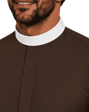 Close-up of a man wearing a brown clerical shirt or robe with a white collar against a plain white background.