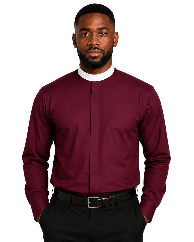 A man wearing a burgundy long-sleeve clerical shirt with a stand collar, paired with black trousers and a black belt, photographed against a solid white background.