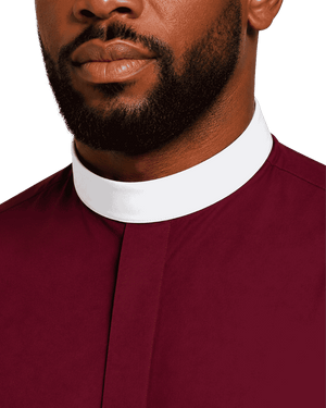 Close-up of a man wearing a burgundy clerical shirt with a white collar, showing the neck and lower face against a plain white background.