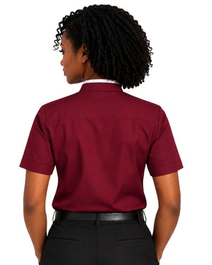 A woman shown from the back wearing a short-sleeve burgundy clerical shirt tucked into black pants, against a plain white background.