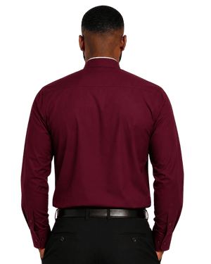 A man viewed from the back wearing a long-sleeve burgundy clerical shirt tucked into black trousers with a black belt, against a plain white background.