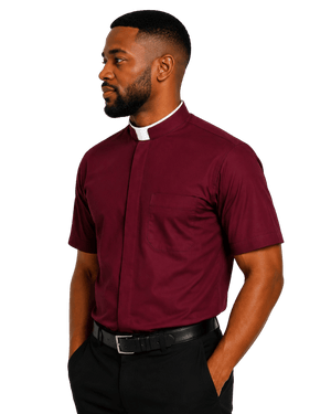 A man wearing a burgundy short-sleeve clerical shirt with a white collar, paired with black trousers and a black belt, shown in profile against a plain white background.