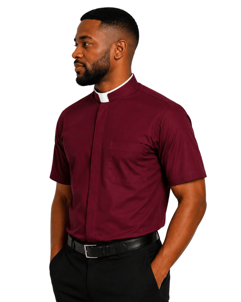A man wearing a burgundy short-sleeve clerical shirt with a white collar, paired with black trousers and a black belt, shown in profile against a plain white background.
