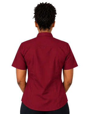 A woman shown from the back wearing a short-sleeve burgundy clerical shirt tucked into black trousers with a black belt, against a plain white background.