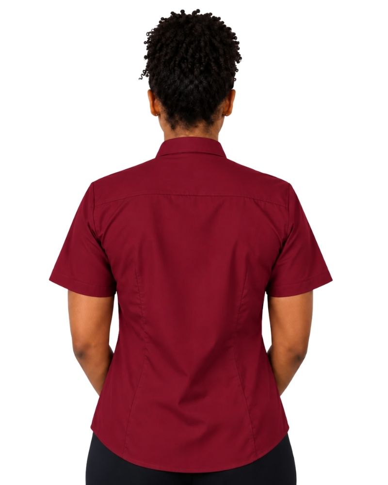A woman shown from the back wearing a short-sleeve burgundy clerical shirt tucked into black trousers with a black belt, against a plain white background.