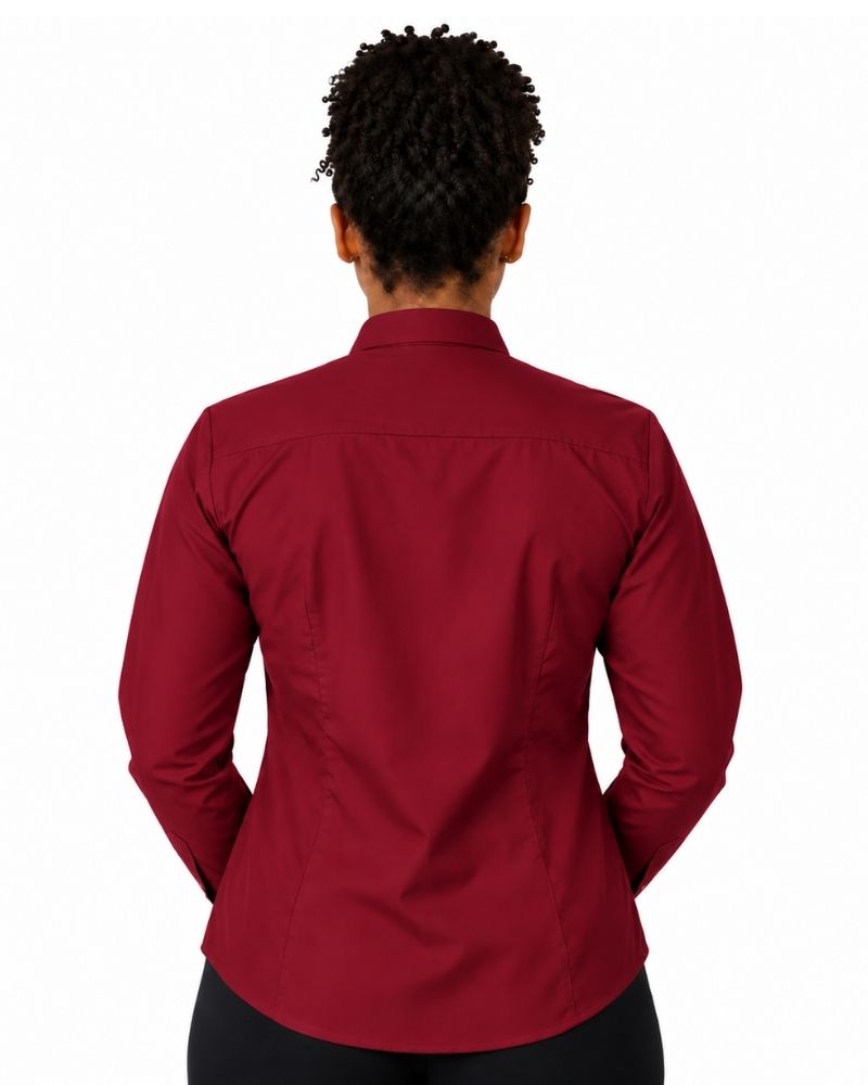 A woman shown from the back wearing a long-sleeve burgundy clerical shirt tucked into black trousers with a black belt, against a plain white background.