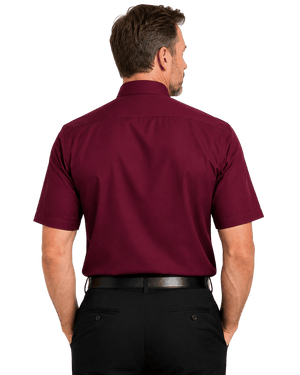 A man viewed from the back wearing a short-sleeve burgundy clerical shirt and black trousers, isolated on a white background.