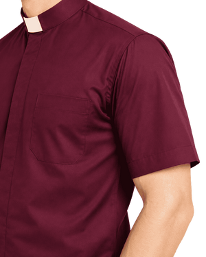 A close-up of a man wearing a short-sleeve burgundy clerical shirt with a white collar, showing the chest pocket and shoulder area against a plain white background.
