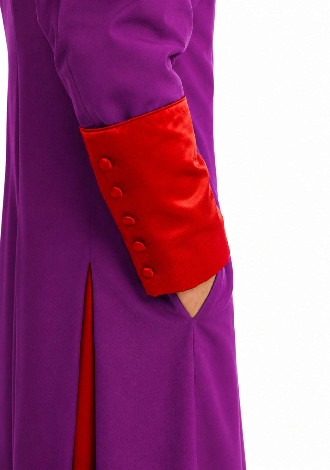 Close-up of a purple robe with red cuffs and buttons on a white background
