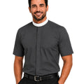 A smiling man wearing a dark gray short-sleeve clerical shirt with a white collar, paired with black trousers and a black belt, against a plain white background.