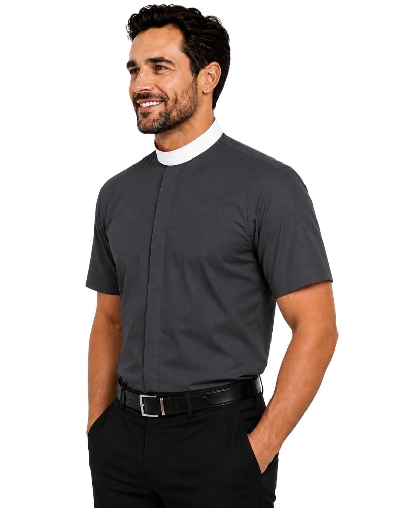 A man wearing a dark gray short-sleeve clerical shirt with a white collar, paired with black trousers and a black belt, photographed against a solid white background.