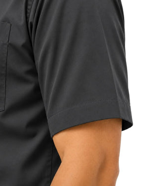 Close-up of a man wearing a dark charcoal gray short-sleeve clerical shirt, showing the sleeve cuff and side pocket against a plain white background.