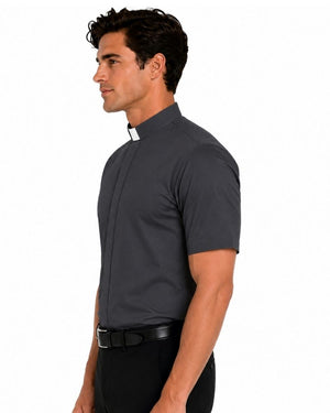 A man in profile wearing a dark gray short-sleeve clerical shirt with a white collar tab, paired with black trousers and a black belt, against a plain white background.