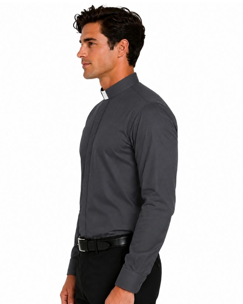 A man in profile wearing a dark gray long-sleeve clerical shirt with a white and black clerical collar, paired with black trousers and a black belt, against a plain white background.