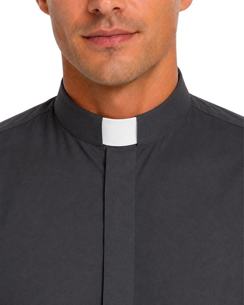 Close-up of a man wearing a dark charcoal gray clerical shirt with a white collar tab, shown against a plain white background.