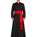 A man modeling a Classic Black Clergy Cassock with Red Trim a wide red waist sash and a matching red draped scarf with tassels, set against a plain white background.
