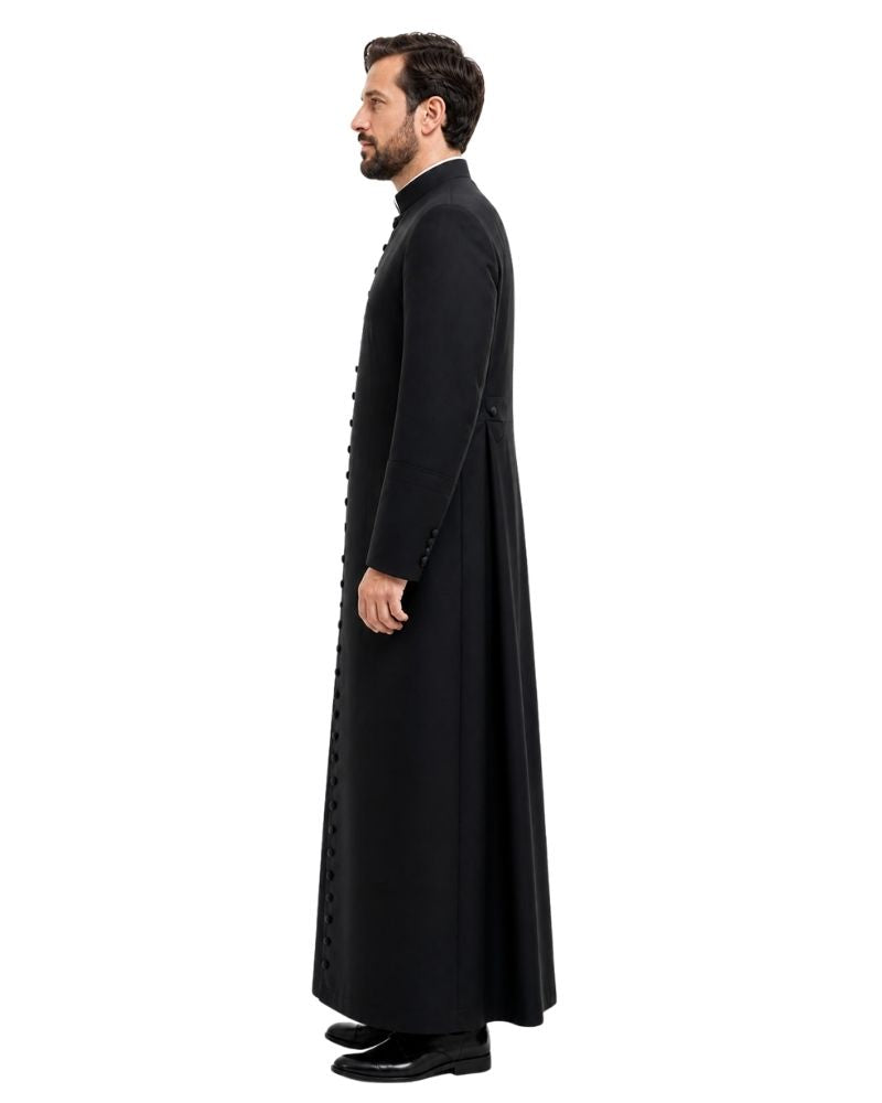 A man shown in profile wearing a long black cassock with a high collar and decorative button details, standing against a plain white background.