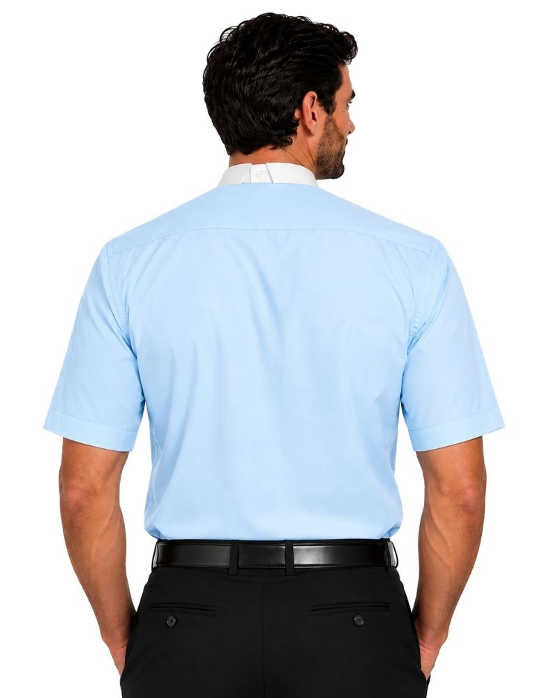 A man viewed from the back wearing a light blue short-sleeve clerical shirt tucked into black dress pants with a black belt, against a plain white background.