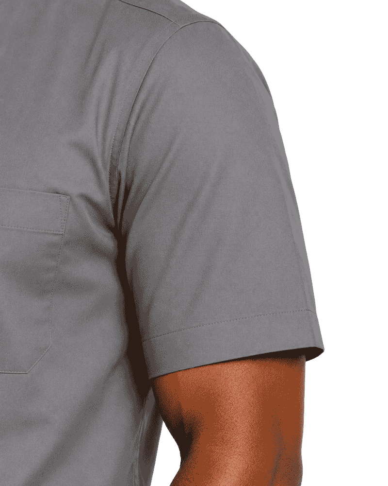 Close-up of a man wearing a short-sleeve gray clerical shirt, showing the chest pocket and sleeve against a plain white background.