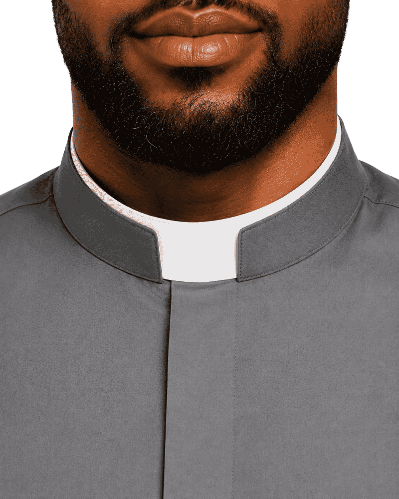 Close-up of a man wearing a gray clerical collar shirt with a white clerical collar underneath, against a plain white background.