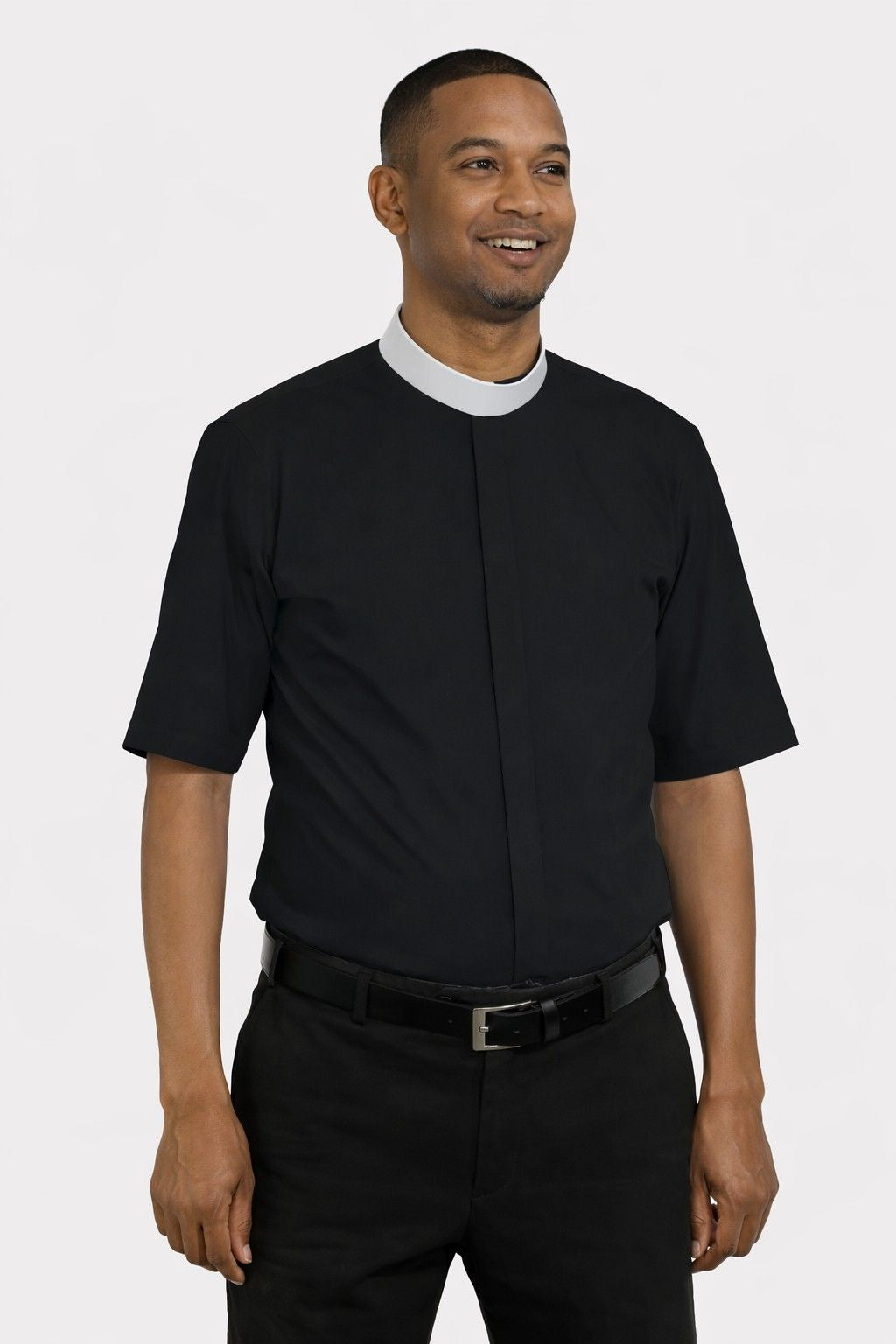 Man wearing a black shirt with a white collar on a plain background