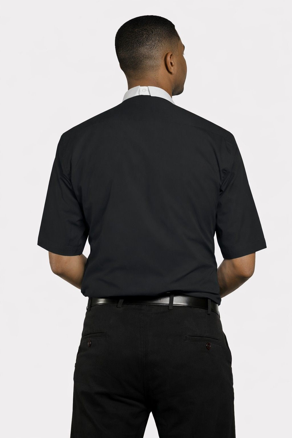 Man wearing a black dress shirt and pants on a white background