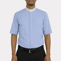 Man wearing a light blue shirt with a white collar and black pants on a white background