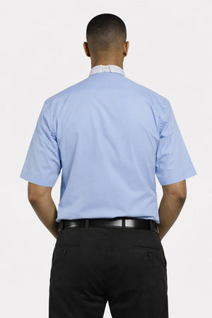 Man wearing a light blue shirt and black pants on a white background