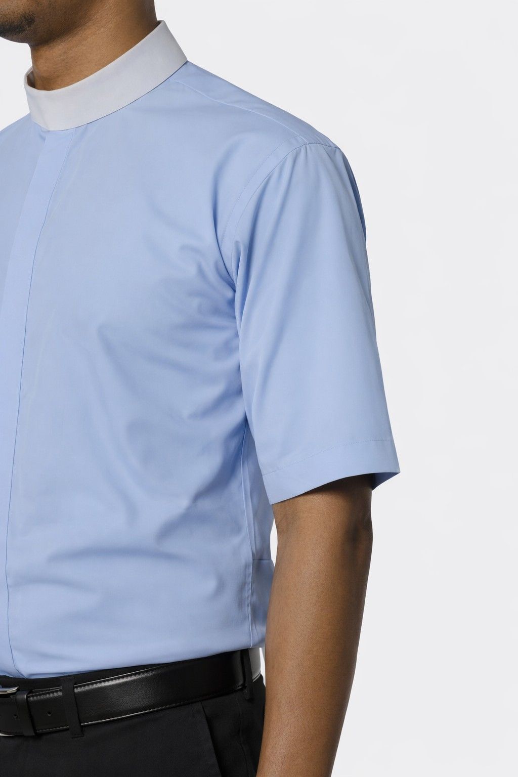 Light blue short-sleeve shirt worn by a man on a white background