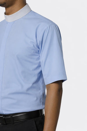 Light blue short-sleeve shirt worn by a man on a white background